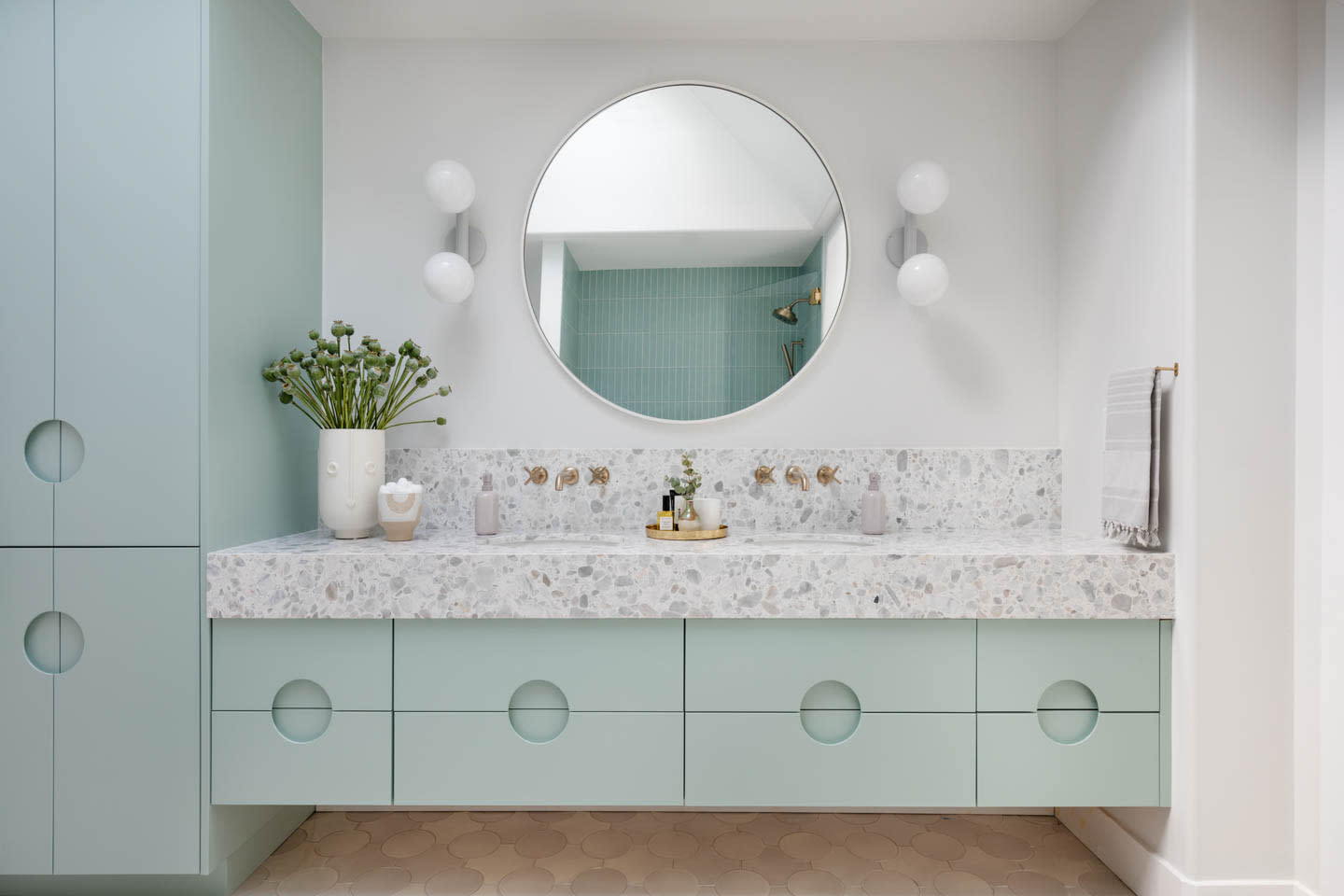 light green vanity with a marble top