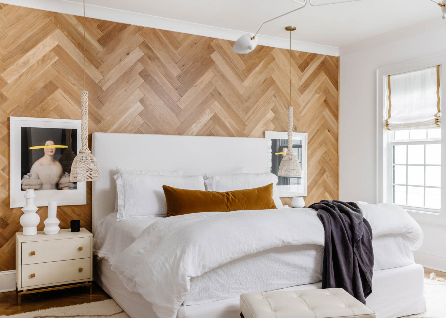 bedroom with an accent wood wall in a herringbone pattern