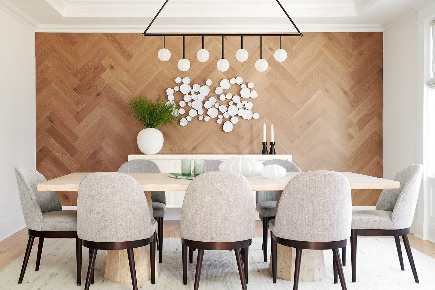 dining room with an accent wood wall in a herringbone pattern
